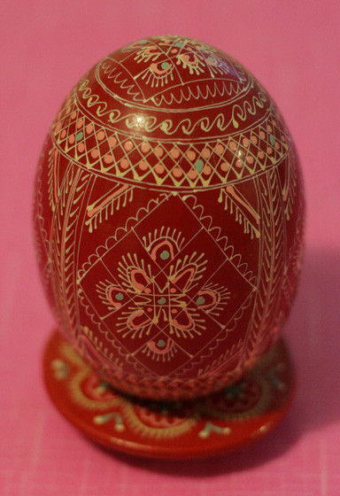 Il tipico uovo ukraino con decorazioni su sfondo rosso